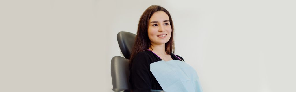 Girl seating on dental chair for tooth extraction at Brantford