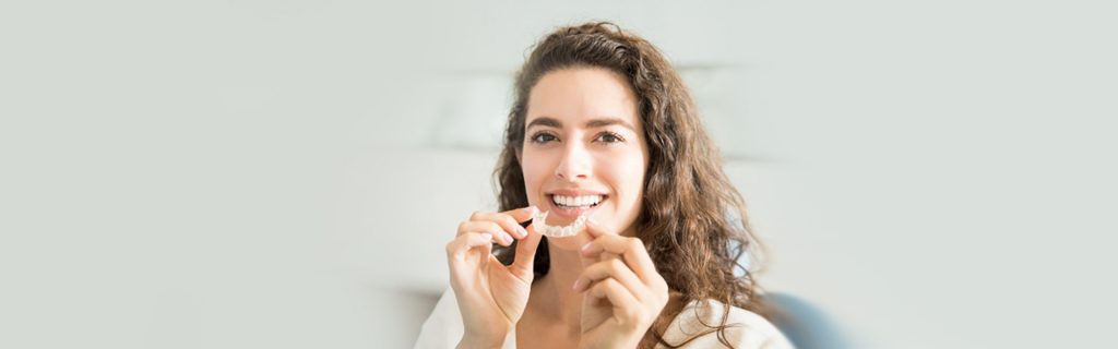 Girl holding Invisalign at Brantford dental clinic