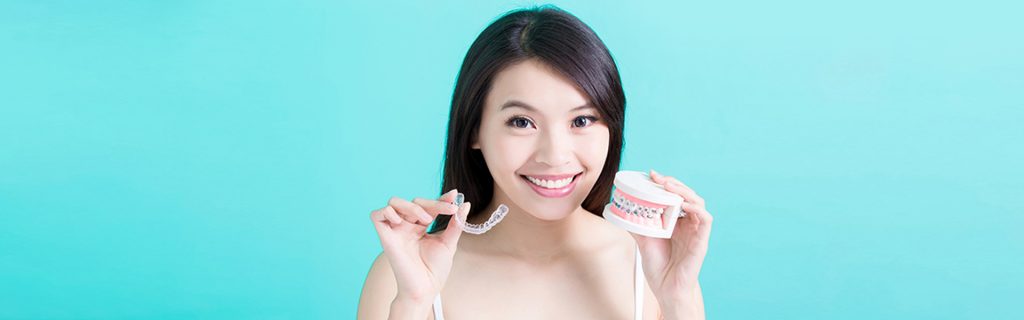 Girl holding Invisalign model