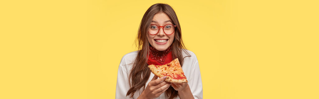 Girl holding pizza pease with wearing a dental braces